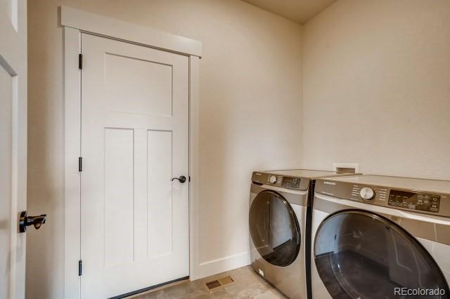 324 Spring Beauty Drive Berthoud, CO 80513 - Photo 22 of 25 a utility room with dryer and washer