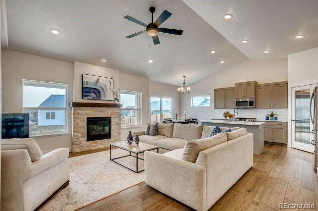 324 Spring Beauty Drive Berthoud, CO 80513 - Photo 3 of 25 a living room with furniture fireplace and a television