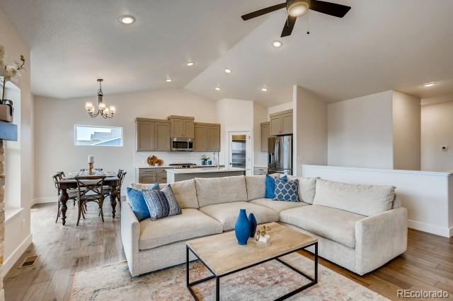 324 Spring Beauty Drive Berthoud, CO 80513 - Photo 4 of 25 a living room with furniture and kitchen view