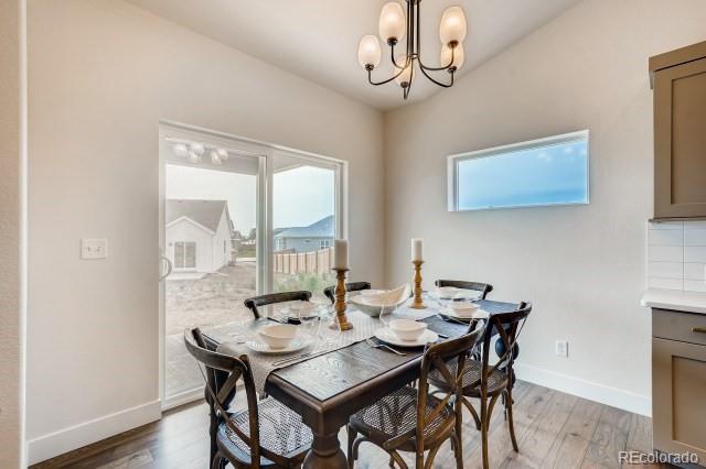 324 Spring Beauty Drive Berthoud, CO 80513 - Photo 7 of 25 a view of a dining room with furniture window and wooden floor