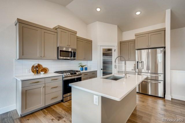 324 Spring Beauty Drive Berthoud, CO 80513 - Photo 9 of 25 a kitchen with white cabinets and stainless steel appliances
