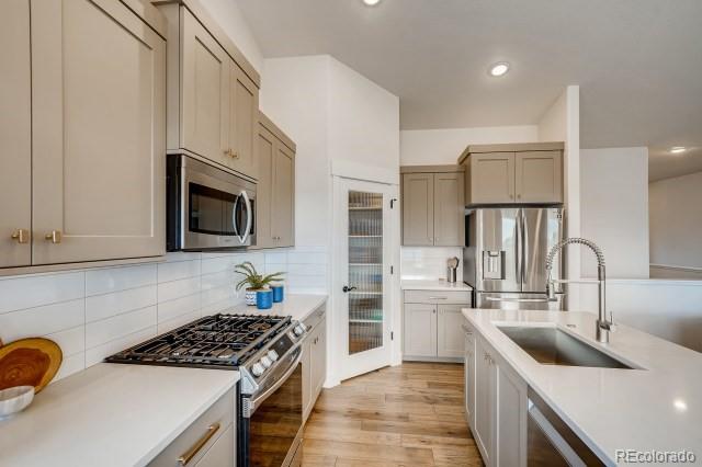 324 Spring Beauty Drive Berthoud, CO 80513 - Photo 10 of 25 a kitchen that has a sink and a stove top oven