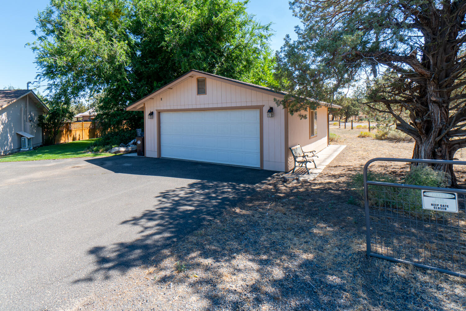 2218 Southwest 79th Street Redmond, OR 97756 - Photo 24 of 54 a front view of a house with a yard and garage