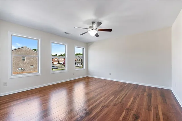 wooden floor in an empty room with a window