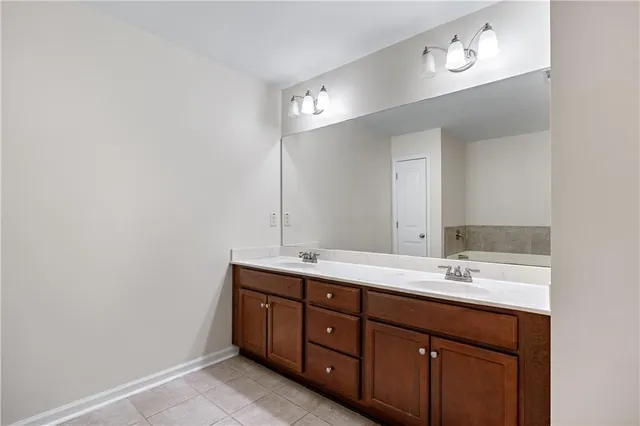 a bathroom with a double vanity sink and a mirror