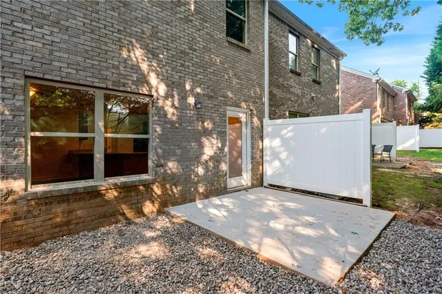 a view of a yard with wooden wall and a large window