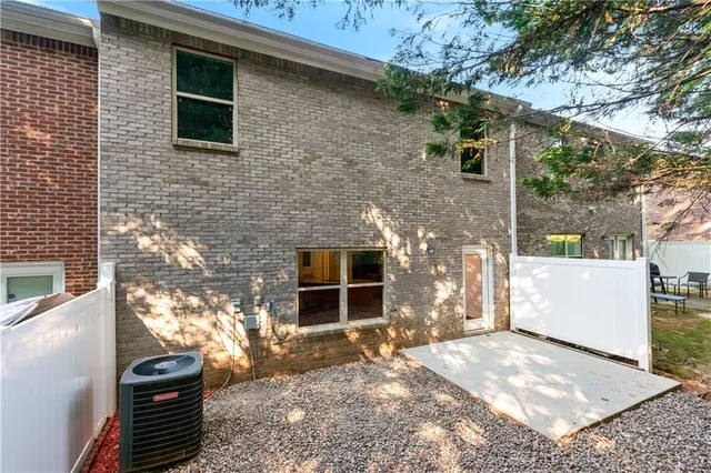 a view of a house with a yard and tree