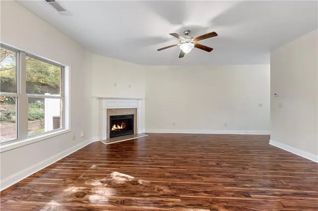 a view of an empty room with window and fire place
