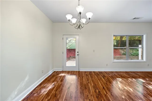 a view of a room with wooden floor and window