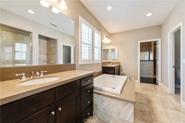 a en suite bathroom with a double vanity sink a mirror and a shower