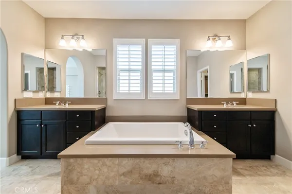 a spacious bathroom with a sink bathtub and a mirror