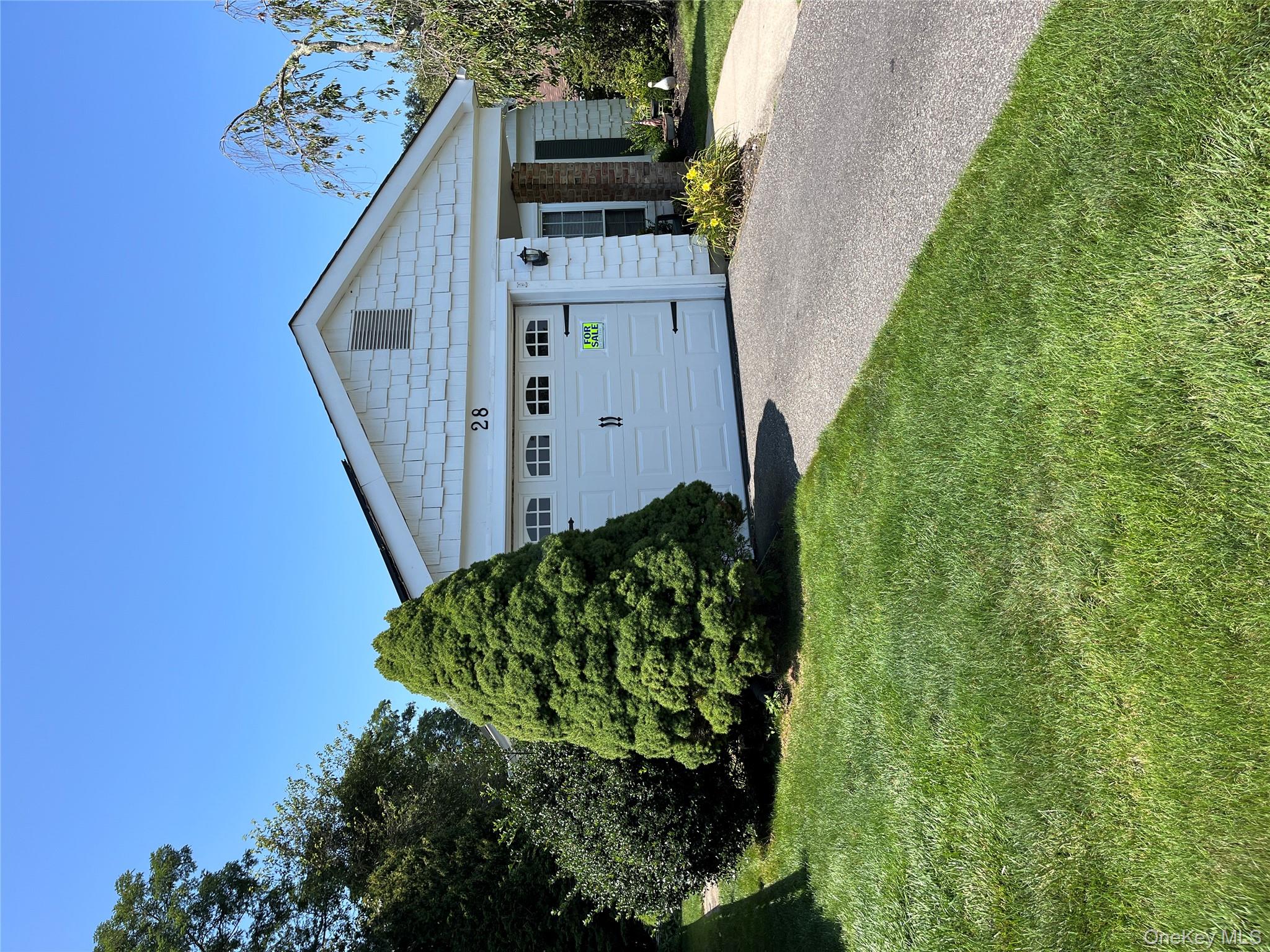 28 Kingston Drive Ridge, NY 11961 - Photo 1 of 1 a front view of a house with a garden