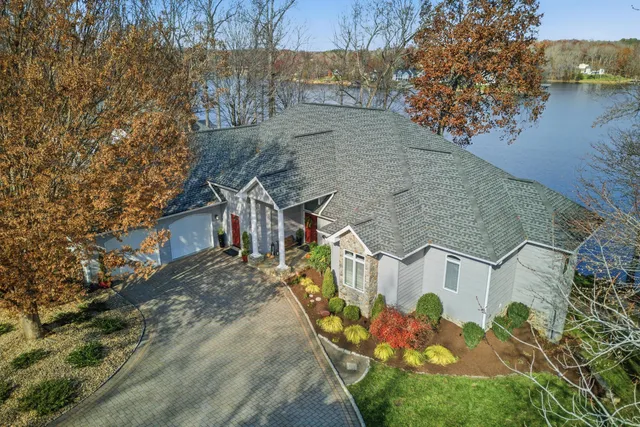 a front view of a house with a yard covered in snow
