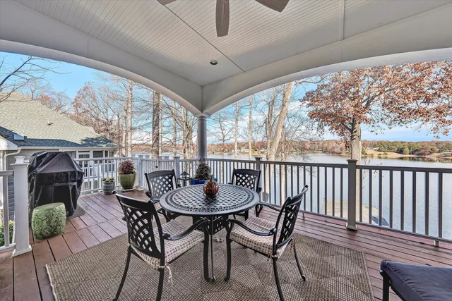 a view of a lake with a big yard and potted plants