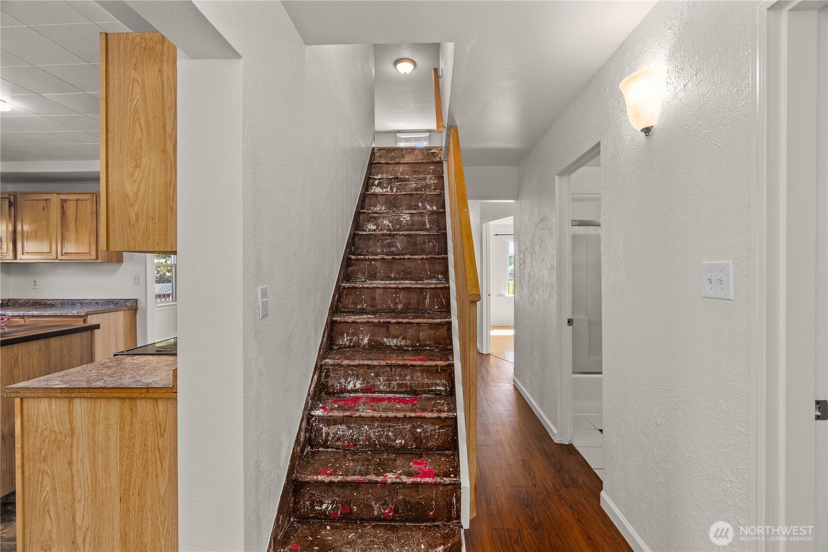 43 Camp Creek Road Montesano, WA 98563 - Photo 14 of 32 a view of a hallway with wooden floor and staircase