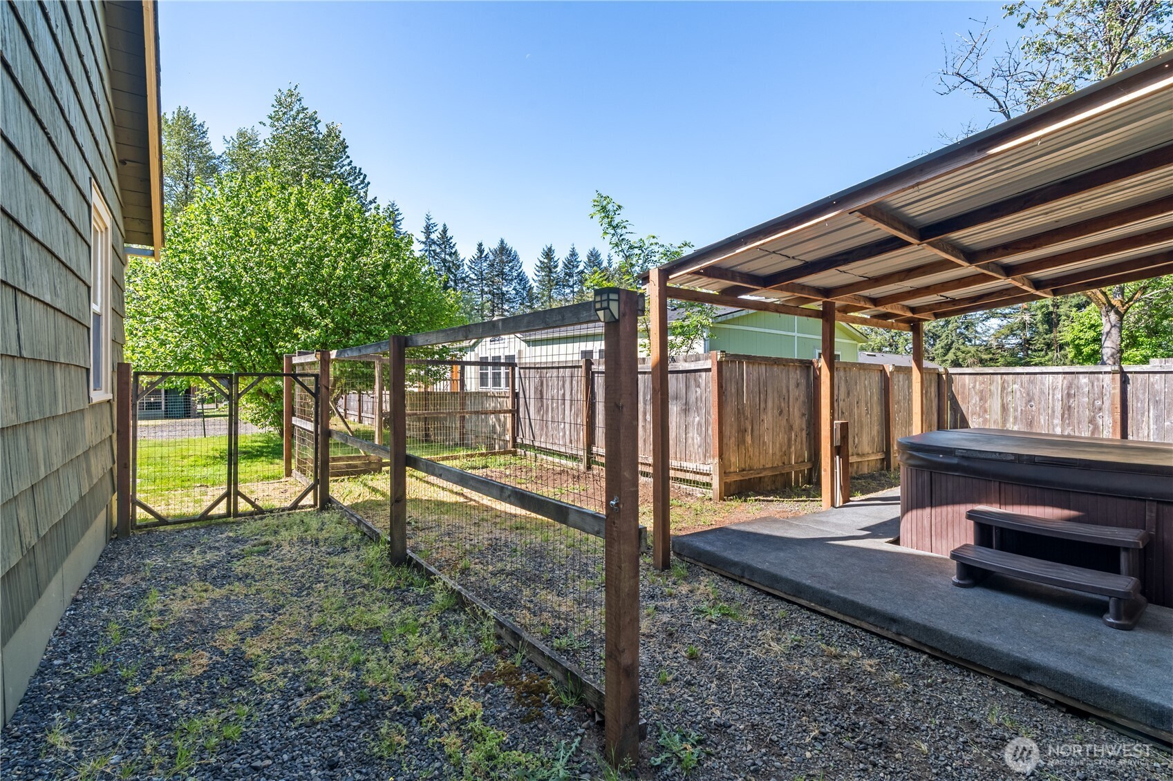 43 Camp Creek Road Montesano, WA 98563 - Photo 19 of 32 a view of a backyard with wooden fence and a bench