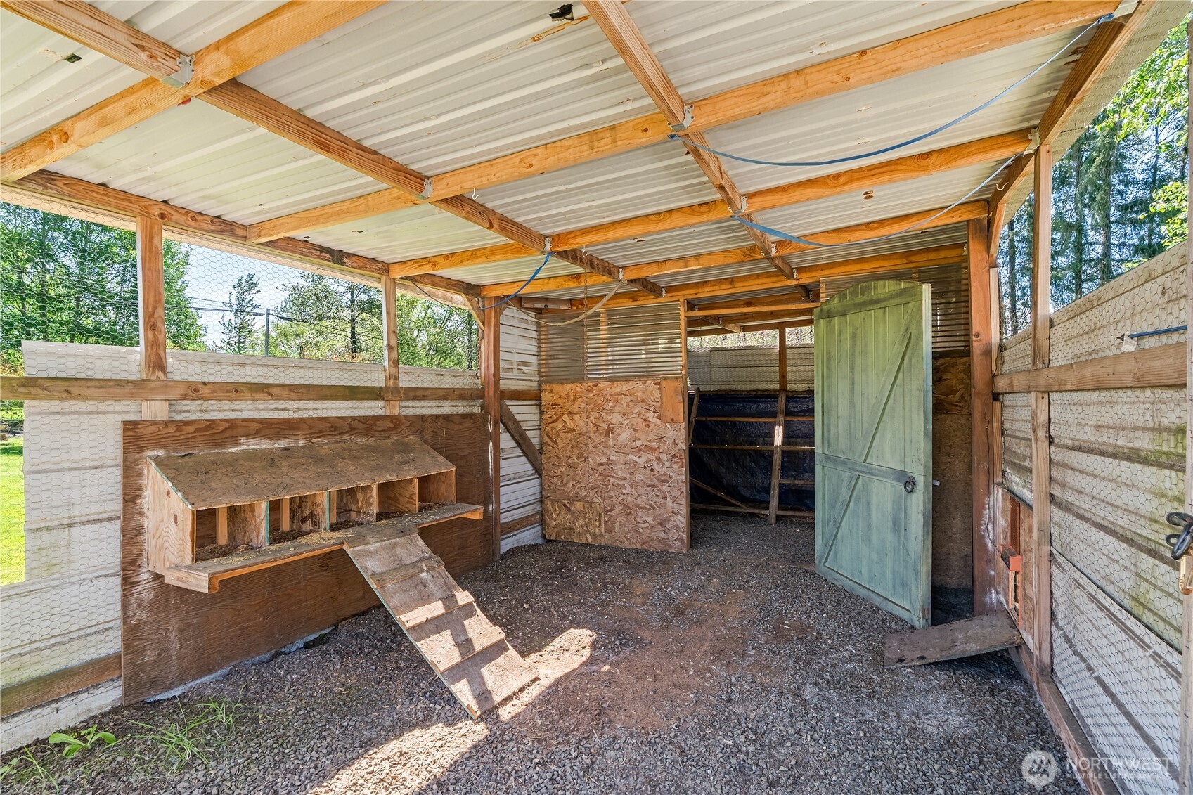 43 Camp Creek Road Montesano, WA 98563 - Photo 20 of 32 a view of a room with wooden walls and a bed