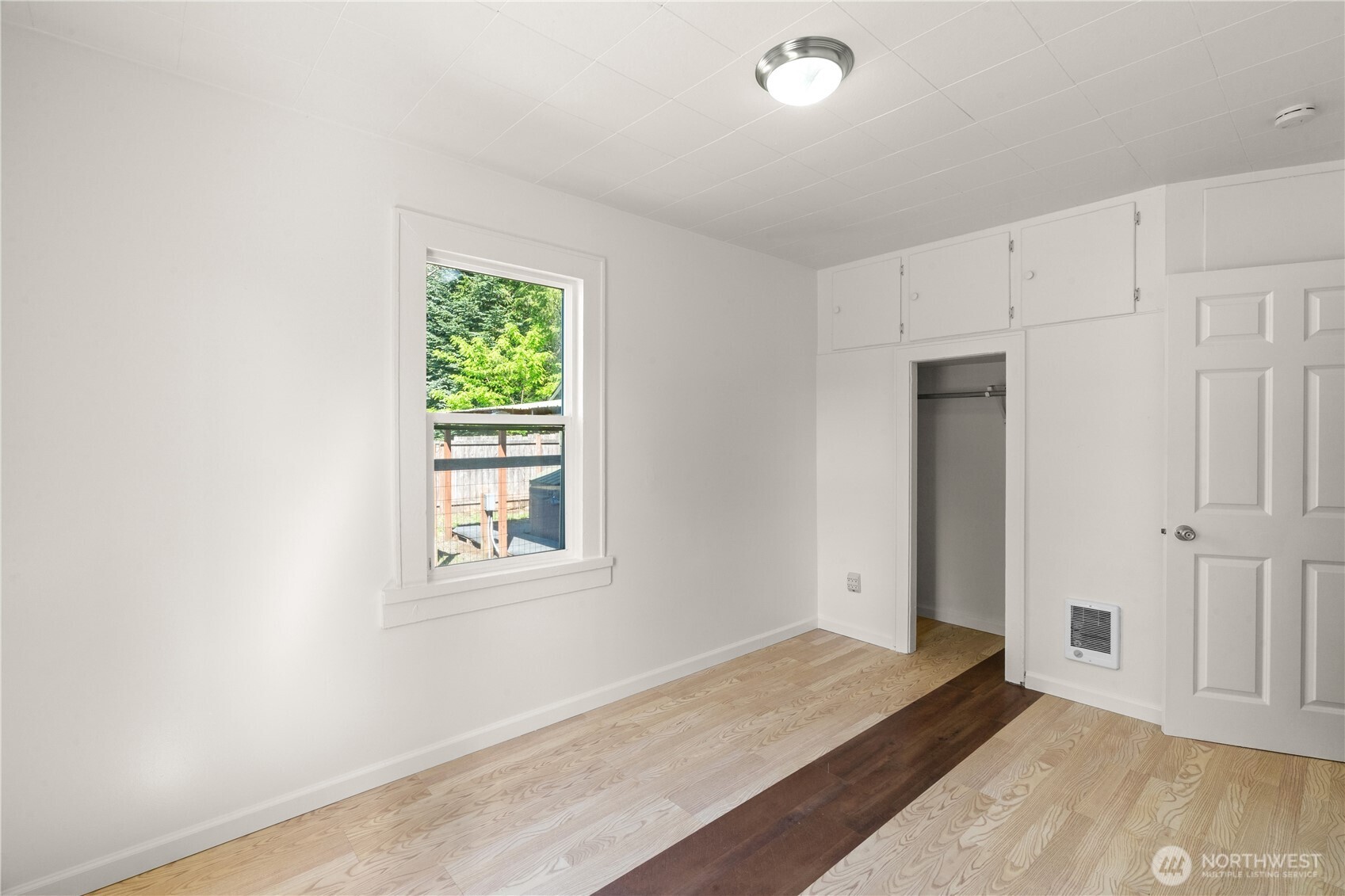43 Camp Creek Road Montesano, WA 98563 - Photo 10 of 32 an empty room with wooden floor and windows
