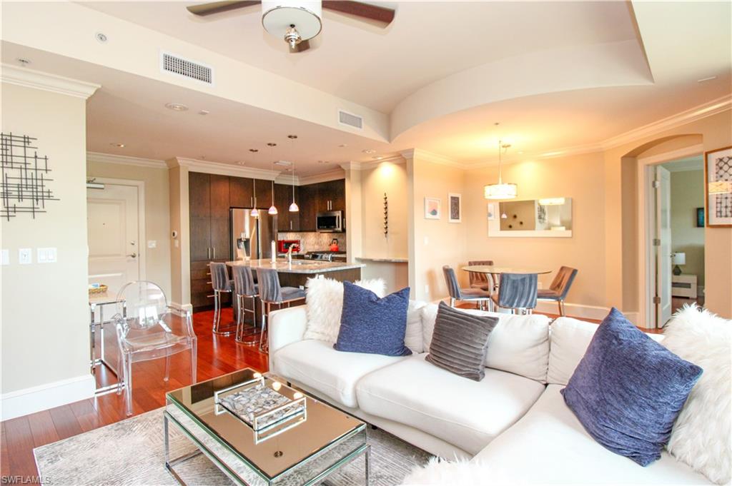 9123 Strada Place, Unit 7410 Naples, FL 34108 - Photo 4 of 50 Living room with dark wood-type flooring, ceiling fan, and crown molding