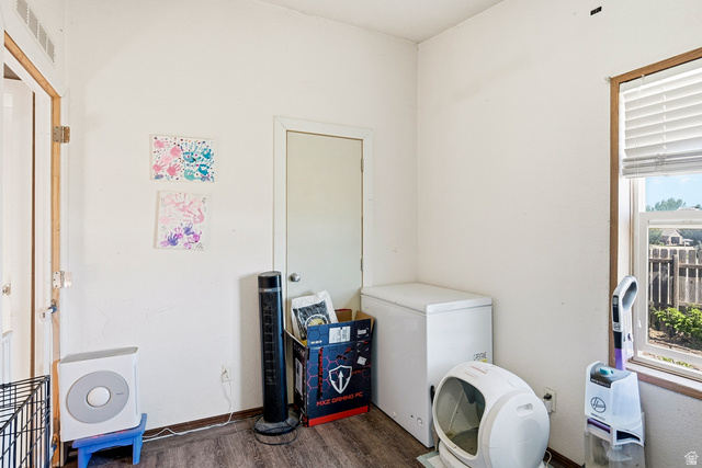 4296 Maple Lane Cedar City, UT 84721 - Photo 25 of 44 Room featuring wood-finish flooring, white walls, and a window with horizontal blinds