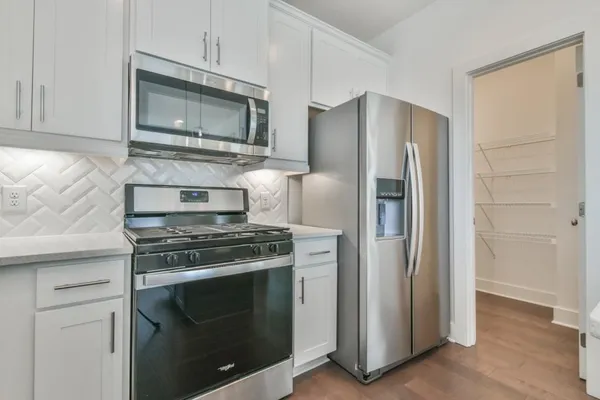 a kitchen with a stove and a microwave