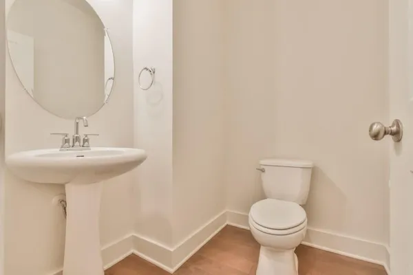 a bathroom with a sink a toilet and mirror