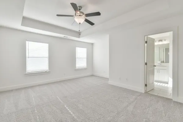 a bathroom with a granite countertop sink a large mirror and a bathtub