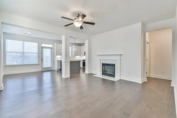a view of an empty room with a fireplace and a window