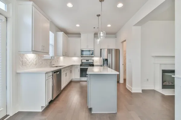 a large kitchen with stainless steel appliances kitchen island granite countertop a large counter top a sink stainless steel appliances and cabinets