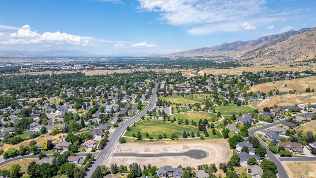1473 Red Fox Court, Unit 4 Logan, UT 84321 - Photo 6 of 19 Expansive aerial view showcasing a developed residential area with mature trees and a distant mountain range