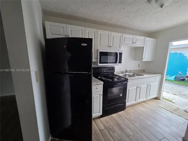 a kitchen with a refrigerator stove and sink