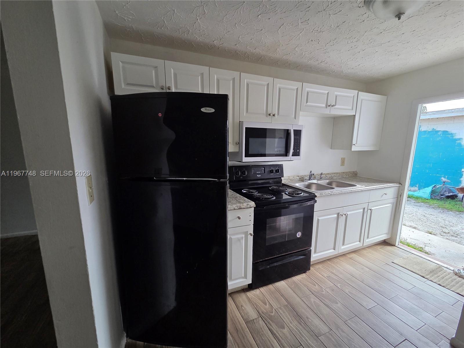 a kitchen with a refrigerator stove and sink