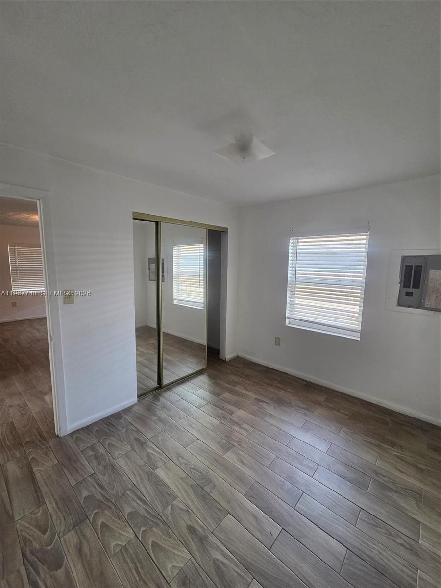 503 North 25th Street, Unit 2 Fort Pierce, FL 34947 - Photo 13 of 19 a view of an empty room with wooden floor and a window