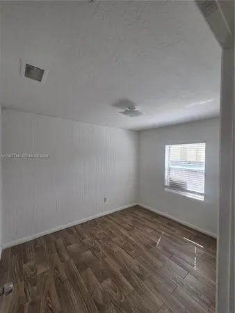 an empty room with a empty space and windows
