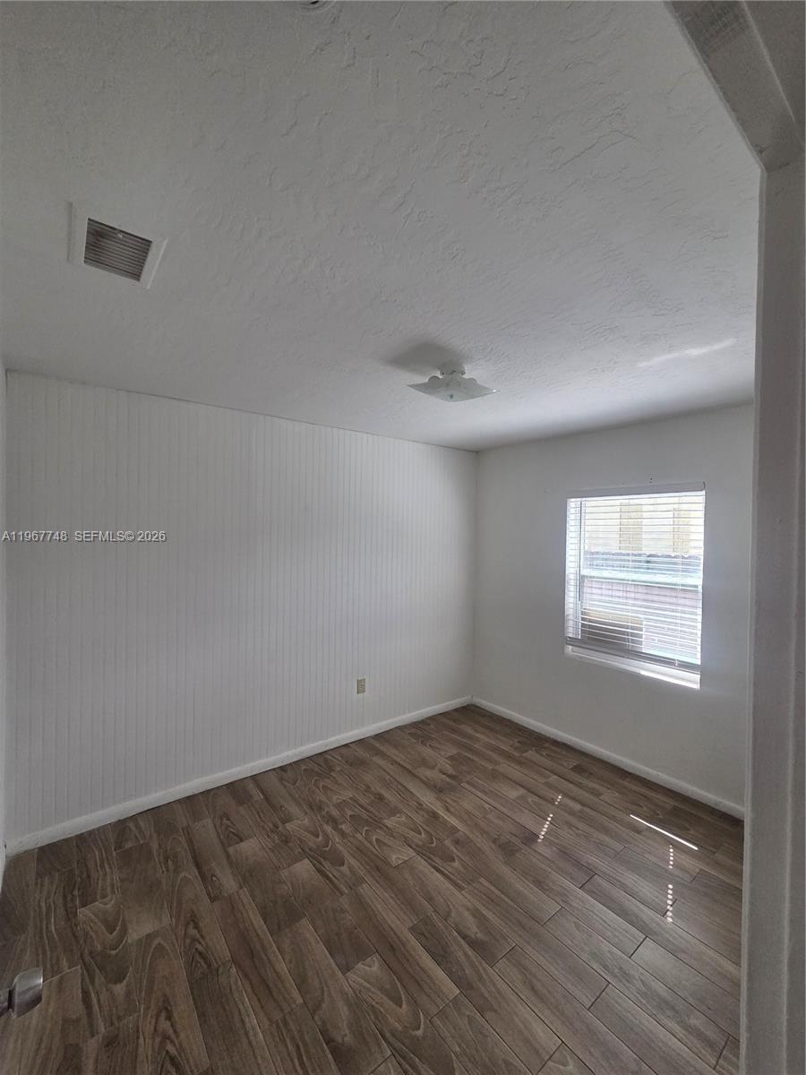 503 North 25th Street, Unit 2 Fort Pierce, FL 34947 - Photo 10 of 19 an empty room with a empty space and windows