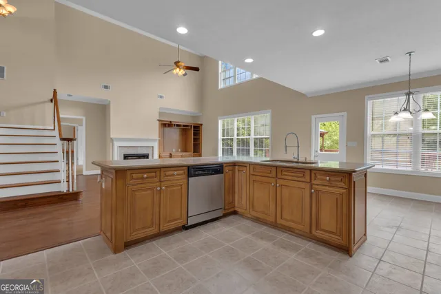 a kitchen with kitchen island granite countertop a sink window and cabinets