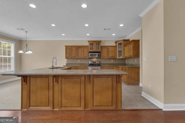 a dining room with furniture a chandelier and wooden floor