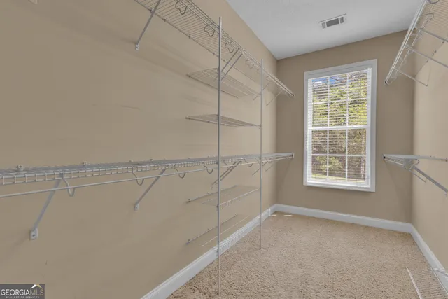 a view of a livingroom with furniture and a bookshelf