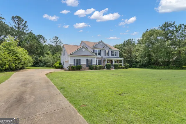 a front view of a house with yard