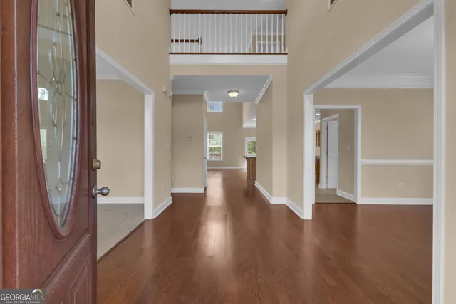 a living room with furniture a lamp and a rug