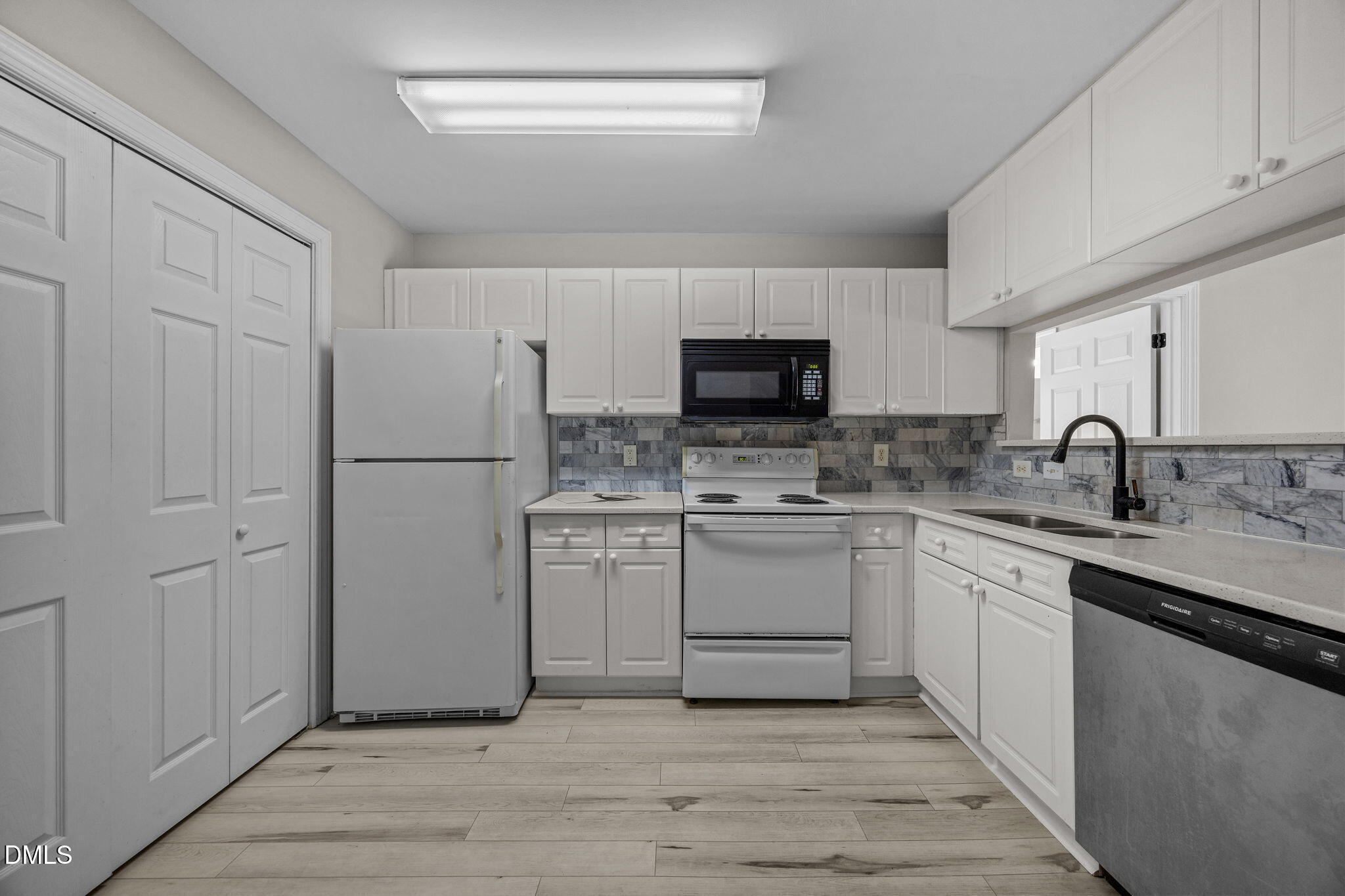 929 Morreene Road, Unit A23 Durham, NC 27705 - Photo 23 of 50 a kitchen with a sink appliances and cabinets