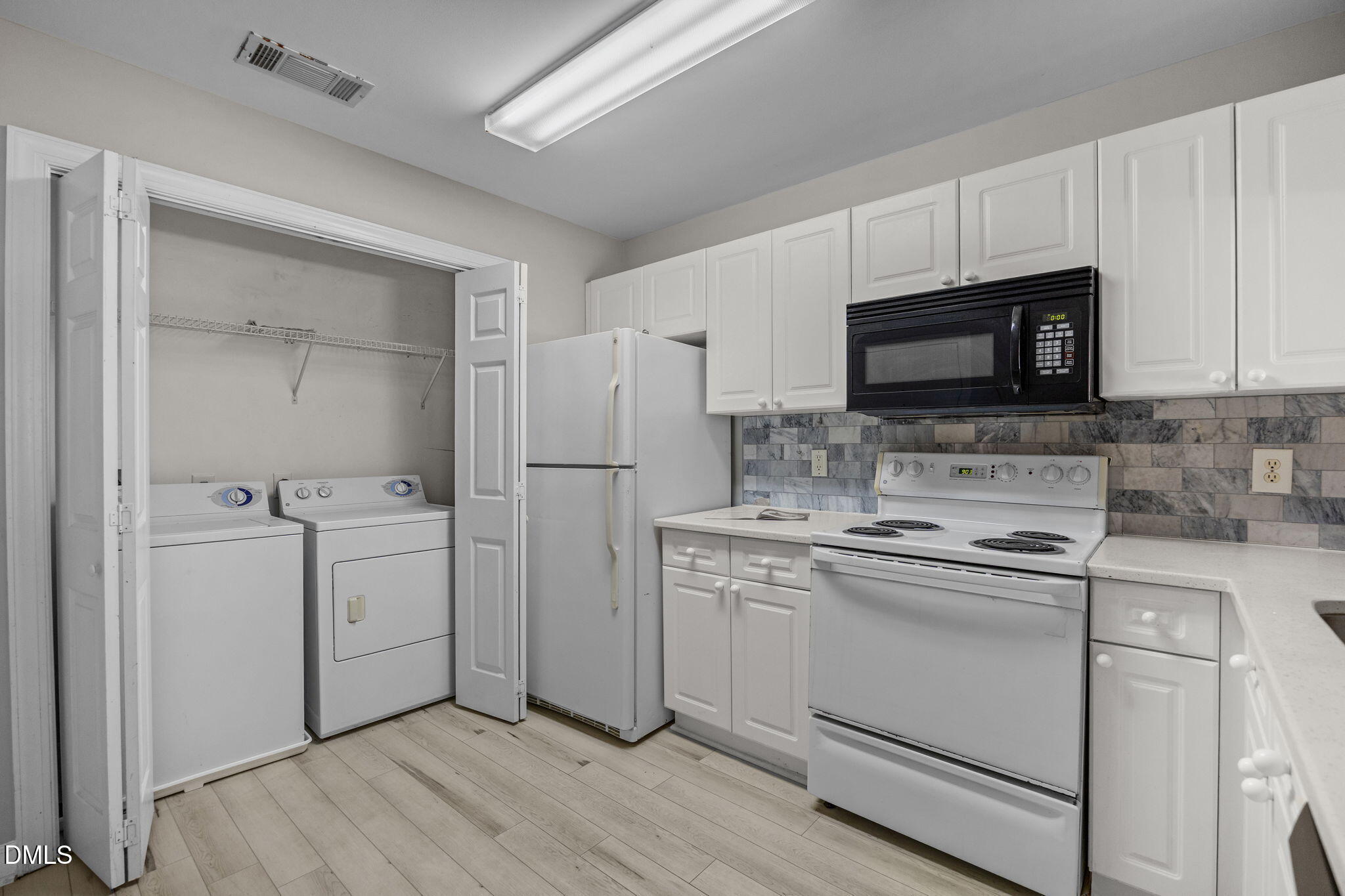 929 Morreene Road, Unit A23 Durham, NC 27705 - Photo 24 of 50 a kitchen with white cabinets stainless steel appliances and sink