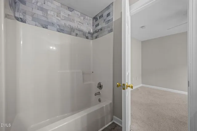 a front view of a house with a garden and a tree