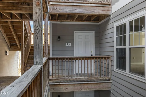 a view of a balcony with wooden floor and windows