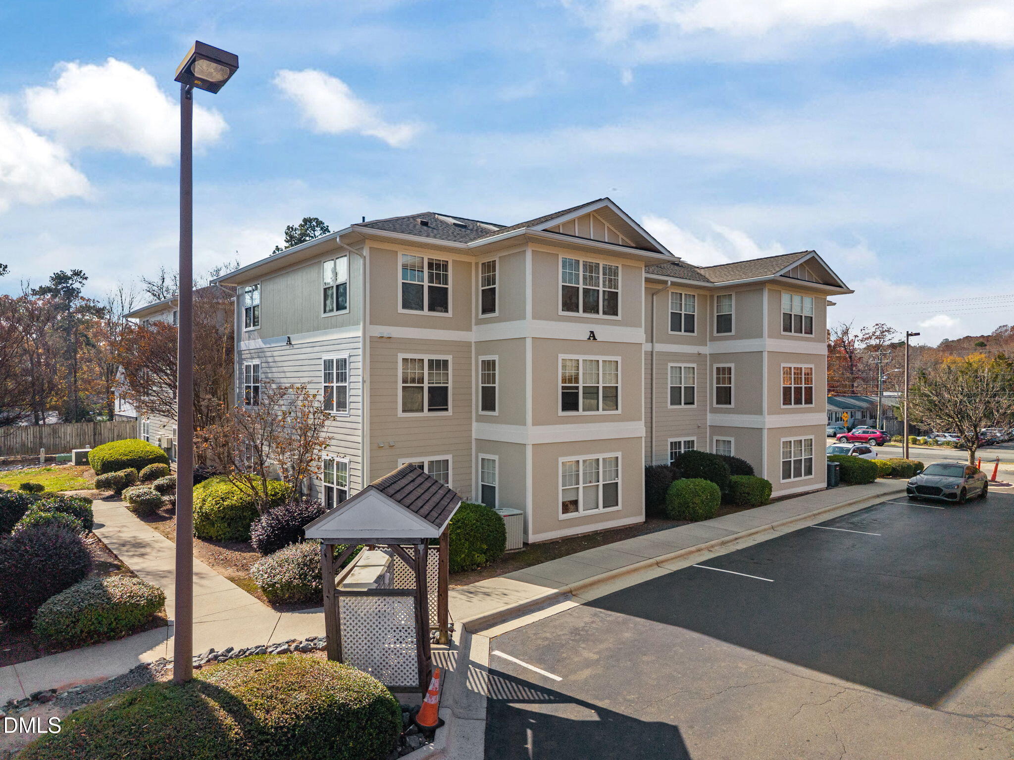 929 Morreene Road, Unit A23 Durham, NC 27705 - Photo 36 of 50 a front view of a house with a garden and a tree