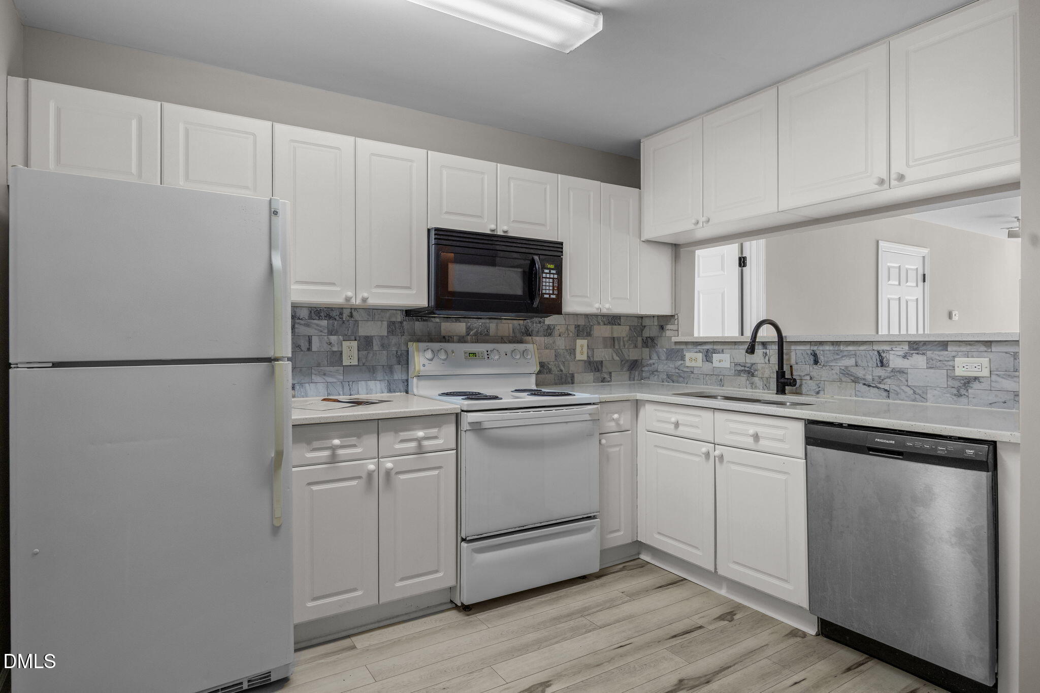 929 Morreene Road, Unit A23 Durham, NC 27705 - Photo 4 of 50 a kitchen with cabinets stainless steel appliances and a sink