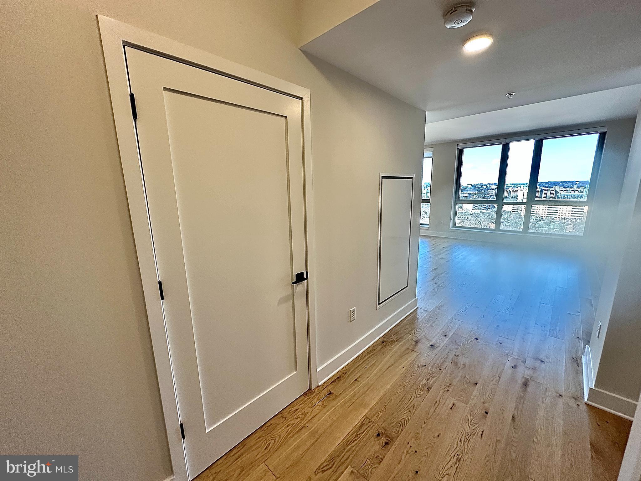 1211 Van Street Southeast, Unit 1201 Washington, DC 20003 - Photo 13 of 58 a view of a hallway with wooden floor and a living room