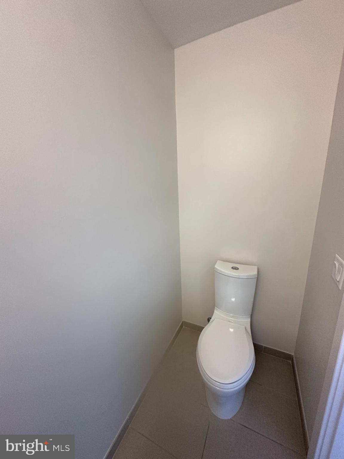 1211 Van Street Southeast, Unit 1201 Washington, DC 20003 - Photo 15 of 58 a white toilet sitting next to a white wall
