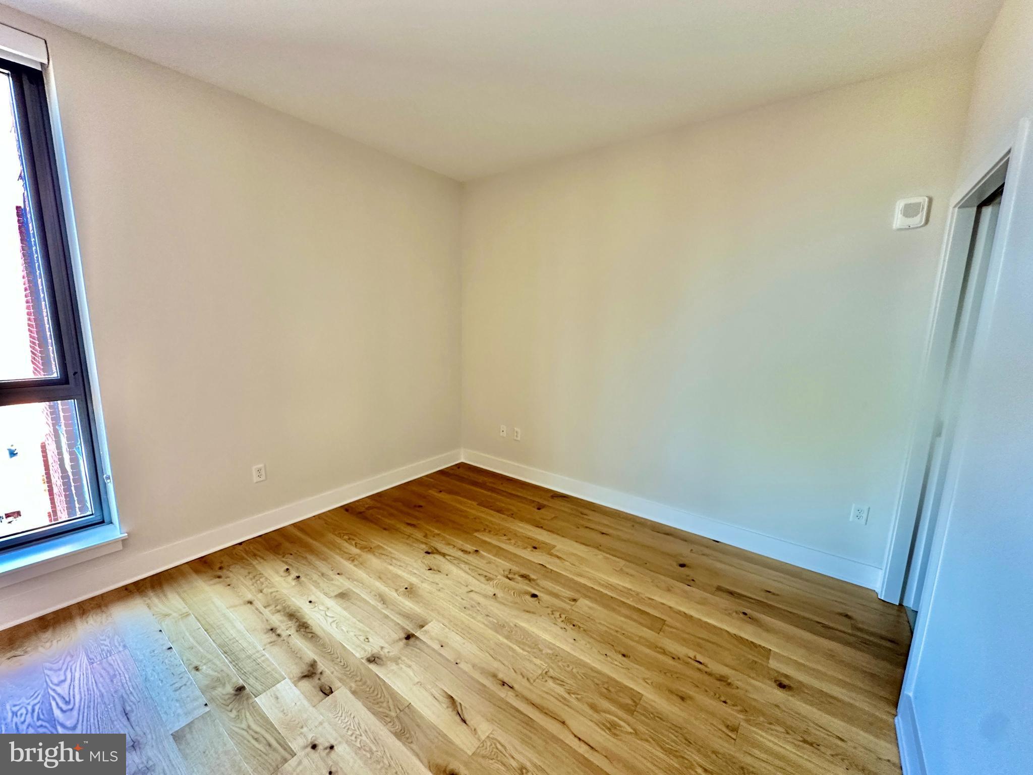 1211 Van Street Southeast, Unit 1201 Washington, DC 20003 - Photo 21 of 58 a view of empty room with wooden floor and fan