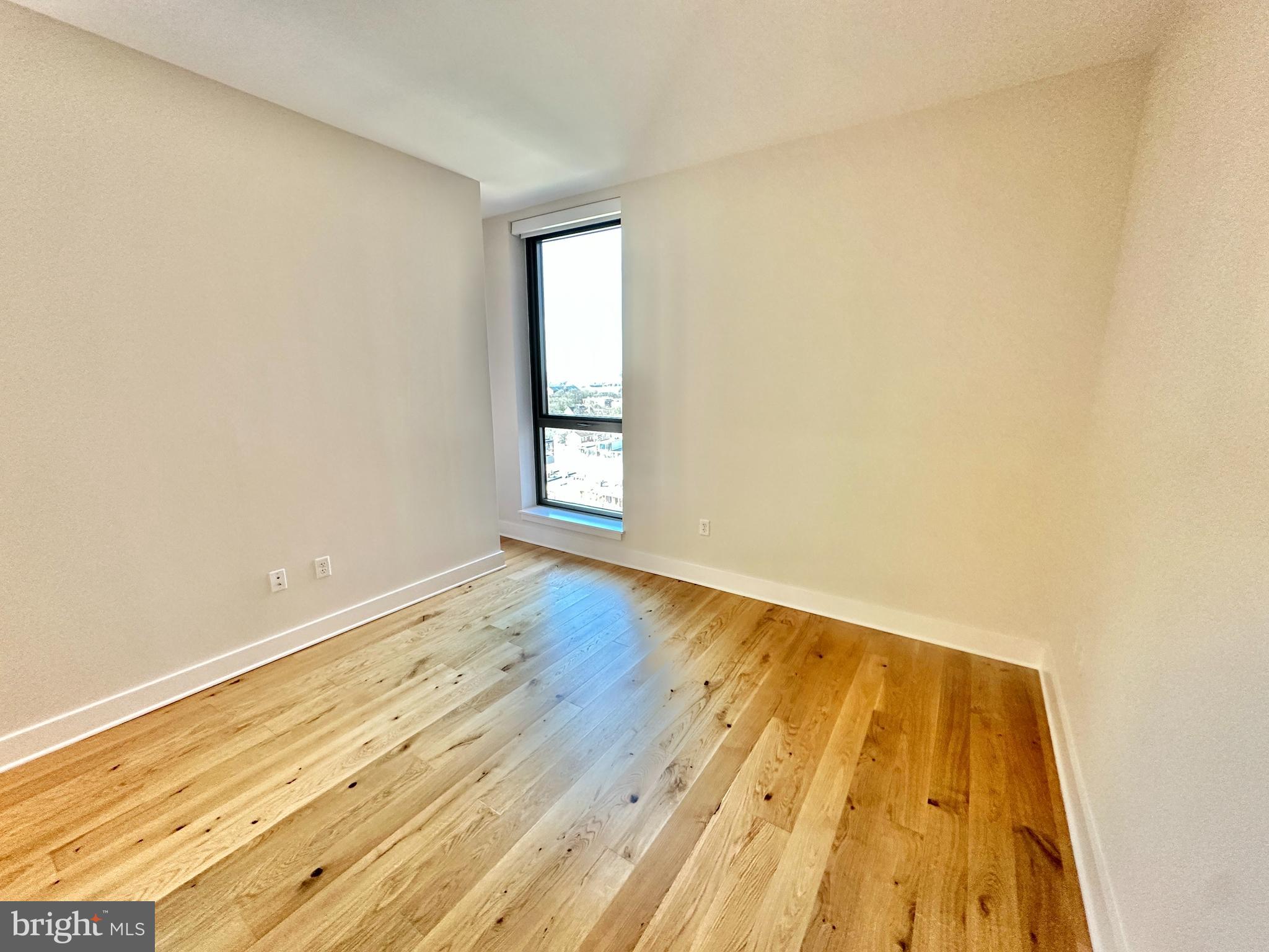 1211 Van Street Southeast, Unit 1201 Washington, DC 20003 - Photo 22 of 58 an empty room with wooden floor and windows